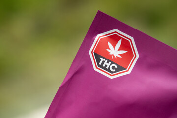 Package of cannabis edibles containing THC, marijuana label warming