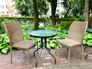 Obraz premium interior with chairs standing near glass tables outside in the park in summer. concept for equipping an outdoor summer cafe