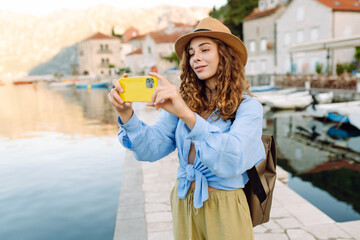 Female tourist taking images of city during leisure time for creating publication in blog....