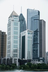 Fototapeta premium Vertical shot of modern skyscrapers in an urban cityscape