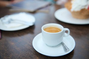 Close-up of a coffee cup on a wooden table in a cafe