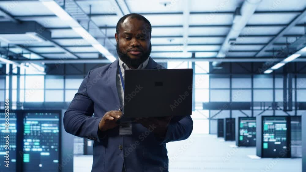 Poster it engineer working on laptop in modern data center, overseeing server operations, system maintenanc