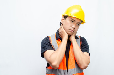 overworked concept illustrated by a sleepy construction worker yawning with hand gestures covering his mouth and stretching his arm. 