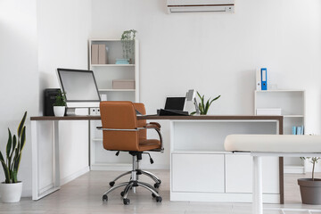 Interior of medical office with workplace and shelf units