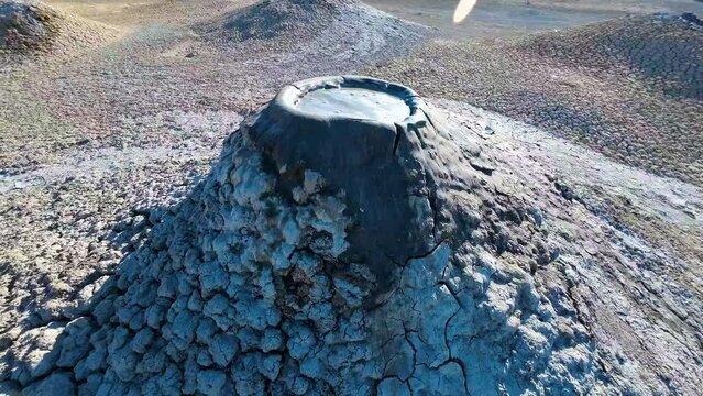 Mud volcano. Always active mud volcanoes surrounded by mountains