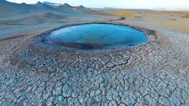 Mud volcano. Always active mud volcanoes surrounded by mountains