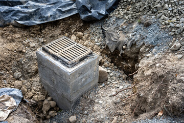New storm water sewar installation in progress, new cement pore with rectangular iron grate on top,...
