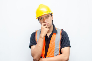 Asian male construction worker in hardhat and orange vest looks sad with crying gesture. stressed overworked concept. workers' insurance concept.