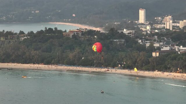 sunset time phuket island beach bay tourist parasailing flight aerial panorama 4k thailand