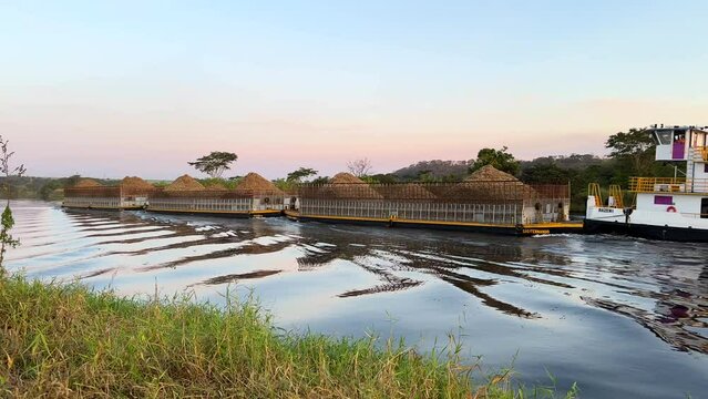 Bariri, Sao Paulo, Brazil - June 8, 2024 - Vessel transporting sugarcane bagasse through the Tiete River waterway