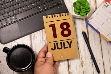 White calendar cubes with date july 18 on yellow background. Creative layout.