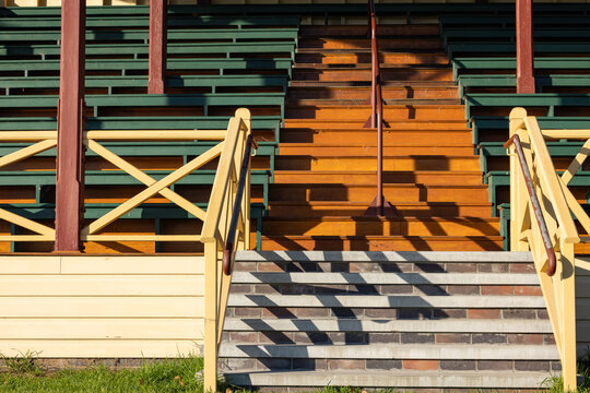 Early morning shadows cast on stairs of empty showgrounds grandstand