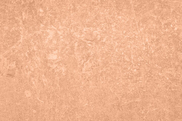 Stone surface of peach fuzz color, top view. Trendy shade of 2024 year