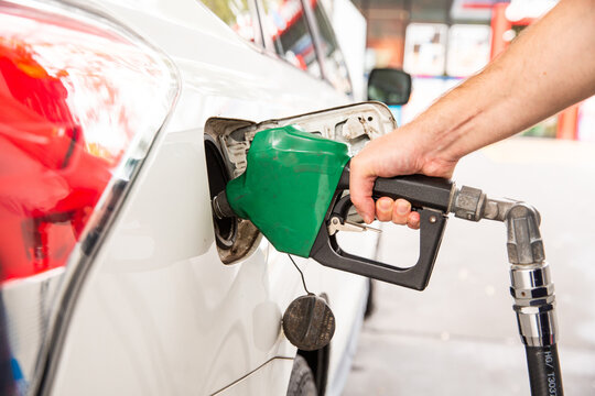 close up of a man pumping petrol at a petrol station