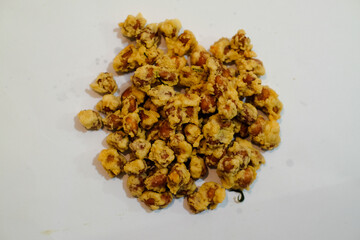 Fried peanuts or kacang disco are a typical Balinese on a white background, Indonesian snack. It tastes so delicious. Made from peanuts and spices with a savory and crunchy taste.