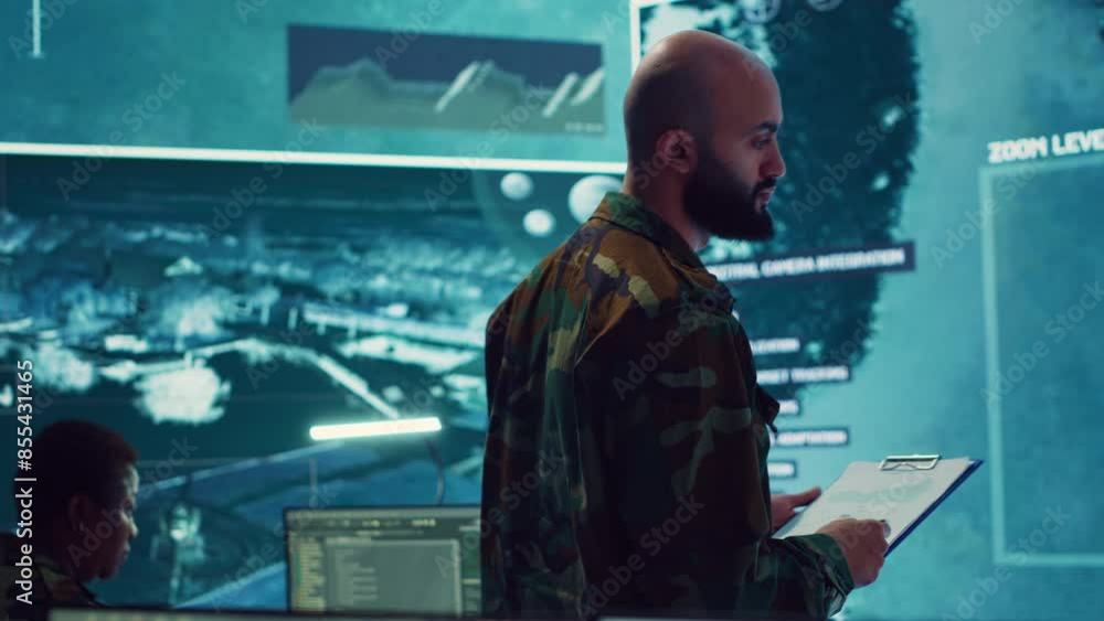 Poster army officer examining real time satellite data on big screen in military power base, gather intelli