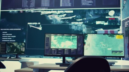 Government anti terrorism operation room equipped with a big display and surveillance on satellite radar cctv used for reconnaissance. Empty military command center with high tech.