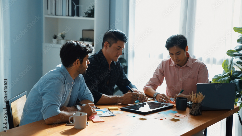 Poster group of diverse people sharing idea while writing at sticky notes. professional smart business team