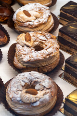 Freshly baked stuffed sweet Paris-Brest pastries in traditinal French bakery in small village in Provence