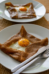 Galettes pancakes from Brittany made with buckwheat flour and served with savoury toppings, smelted cheese and eggs