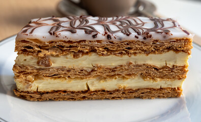 Portion of french mille-feuille cake, vanilla or custard slice, Napoleon puff pastry layered with pastry cream in bakery