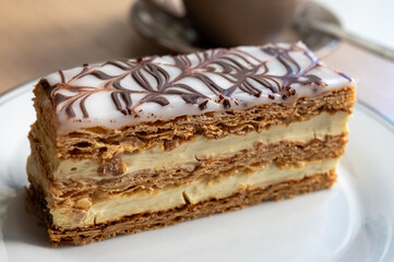 Portion of french mille-feuille cake, vanilla or custard slice, Napoleon puff pastry layered with pastry cream in bakery