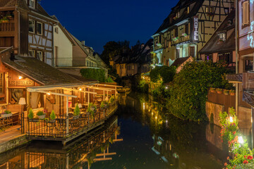 A colored night and reflection in Petite Venise of Colmar in France on 15th march 2024