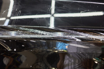 Workshop process of applying protective film to safeguard car headlights from scratches and damage