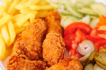 Detail of a Delicious Fast-Food Meal with Chicken drumsticks. Delicious appetizing meal in a menu of a restaurant
