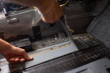 Tunning service worker install soundproofing material inside car interior