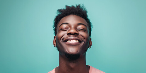 Fototapeta premium Joyful man portrait on turquoise background, a natural portrait of a man expressing joyful