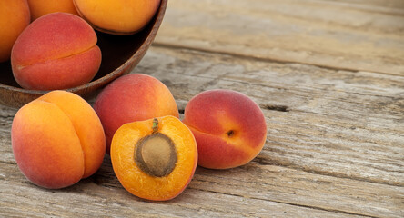 Pile of ripe apricots isolated on rustic wooden table