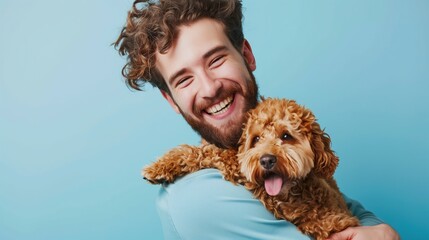 Photo of a happy man with his Goldendoodle, both smiling joyfully, isolated on a light blue background