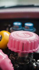 a two pink plastic knobs and a yellow plastic ball