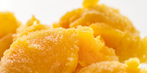 Lush tropical mango and papaya sorbet, a closeup of lush tropical mango and papaya sorbet, vibrant orange and yellow, set against a white background