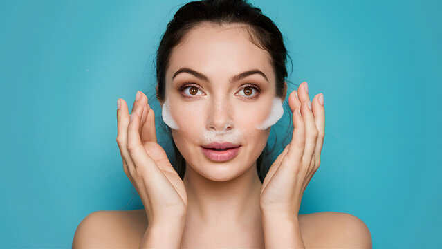 A woman is smiling and holding her hands up to her face