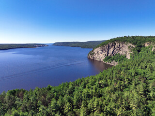 Steep cliffs and thick forest on the north shore of the Ottawa River in Quebec's Pontiac Region