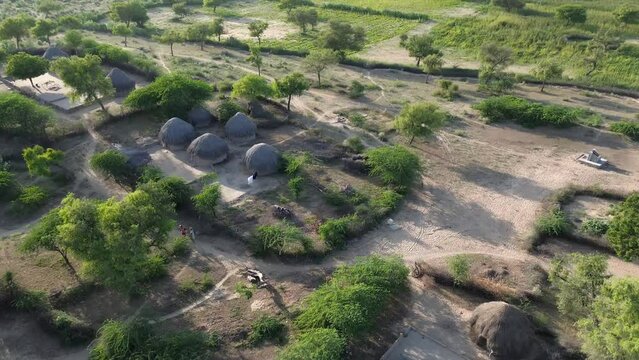 desert life in Tharparkar village, traditional desert houses and wooden huts, Amidst the world's largest desert, thar Desert landscape life aerial view.
