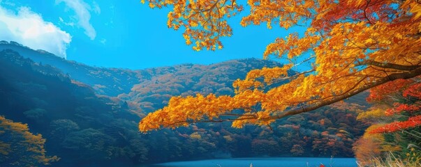 Scenic autumn landscape with vibrant foliage and a serene lake under a clear blue sky.