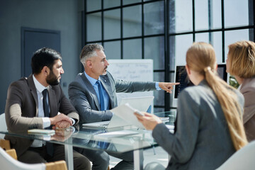 Fototapeta premium High angle view of business people having a brainstorming session.