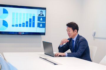 会議室でリモート会議をするビジネスマン