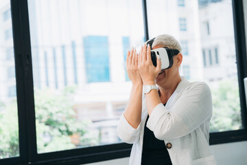 Woman wearing a white shirt and black jacket is wearing a virtual reality headset.