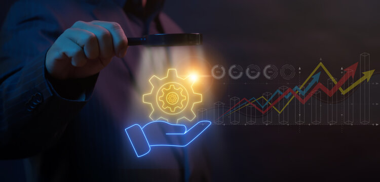Concept for teamwork, target, motivation, mission, achievement, growth and success business. Manifying glass focus on glowing neon line human hand holding cogwheels icon.