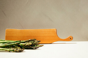 Fresh ripe green asparagus on a concrete background. Harvest asparagus, bunches. Healthy eating concept. Front view