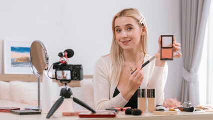 Young woman making beauty and cosmetic tutorial video content for social media. Beauty blogger...