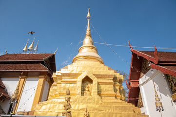 Beautiful golden pagoda in Wat Akkho Chai Khiri temple an iconic landmark in Chae Hom district,...