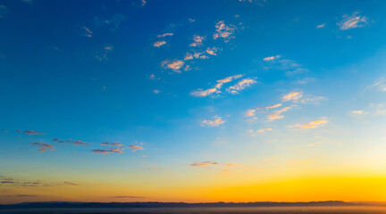 Enjoy a panoramic view of the skyline. The sun rises in the morning sky with colorful clouds. and beautiful cloud patterns In the soft light of the morning	