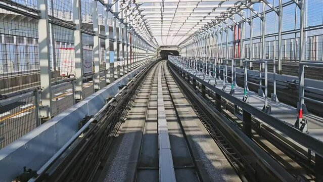 Time lapse of automatic train moving forward to tunnel on train line of odaiba tokyo, japan.