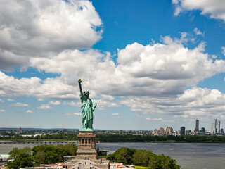 Fototapeta premium The Statue of Liberty over the Panorama of New York cityscape. New York city skyline with statue of liberty. The statue of Liberty and Manhattan.