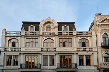 Facade of a beautiful building with many balconies and windows in Tbilisi, Georgia.